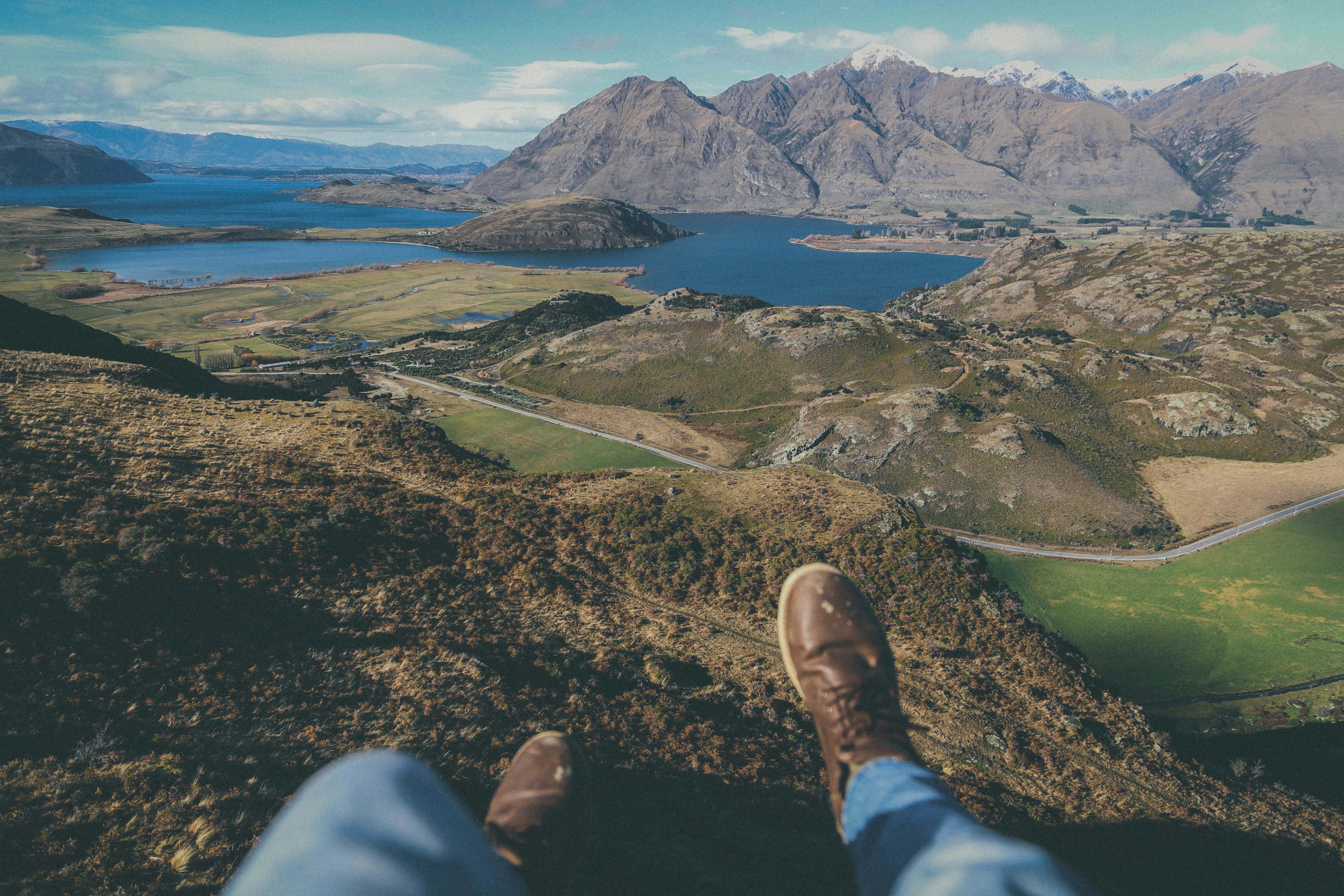 person sitting on cliff during daytime